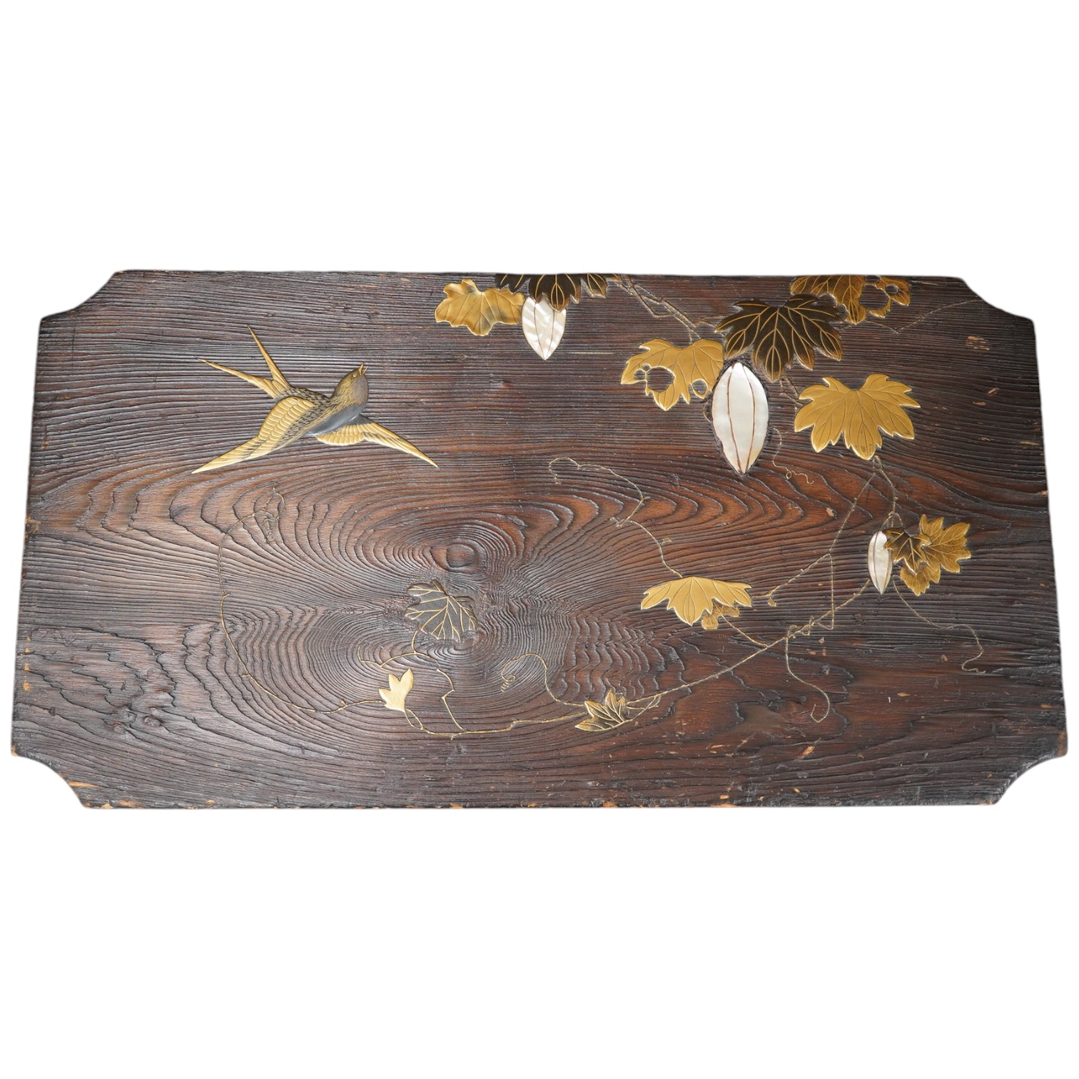 A 19th century Japanese grained wood and lacquer work panel, with mother-of-pearl flower buds, 29 x 55cm. Condition fair to good, minor chips and scratches to the wood.